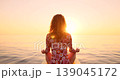 Happy young woman walking on stand up paddle sup board by the sea during summer vacation. Beautiful girl flat water paddling against sea and sky background. Healthy lifestyle concept. Slow motion 139045172
