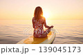 Happy young woman walking on stand up paddle sup board by the sea during summer vacation. Beautiful girl flat water paddling against sea and sky background. Healthy lifestyle concept. Slow motion 139045173