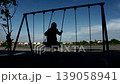 silhouette boy playing swing alone 139058941