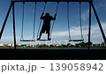 silhouette boy playing swing alone 139058942