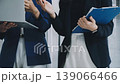 Two business people talk project strategy at office meeting room. Businessman discuss project planning with colleague at modern workplace while having conversation and advice on financial data report. 139066466