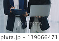 Two business people talk project strategy at office meeting room. Businessman discuss project planning with colleague at modern workplace while having conversation and advice on financial data report. 139066471