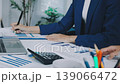 Two business people talk project strategy at office meeting room. Businessman discuss project planning with colleague at modern workplace while having conversation and advice on financial data report. 139066472