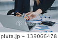 Two business people talk project strategy at office meeting room. Businessman discuss project planning with colleague at modern workplace while having conversation and advice on financial data report. 139066478