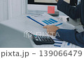 Two business people talk project strategy at office meeting room. Businessman discuss project planning with colleague at modern workplace while having conversation and advice on financial data report. 139066479