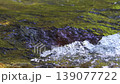 Horizontal, close-up, real-time video of turbulent mountain river with clear water in 4K uhd, from frontal, slightly elevated perspective. Current crashes over underwater rocks, creating air bubbles 139077722