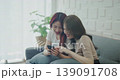 Roommate concept of 4k Resolution. Asian women playing on mobile phones together in the living room. 139091708