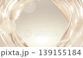 Luminous golden-beige silk waves form a radiant frame, creating an elegant cosmetic backdrop ideal for beauty and skincare branding. 139155184