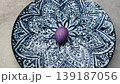 Purple easter egg spinning on a decorative plate 139187056