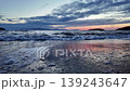 Cinematic Low Angle Sunset Over Aegean Sea with Gentle Waves Crashing on Sandy Beach in Bodrum Turkey 139243647