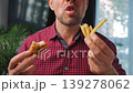 Junk food advertisement concept. Man eating fried chicken, enjoying fast food. 139278062