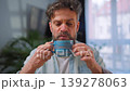 Happy man drinking coffee at relaxed home environment closeup. 139278063