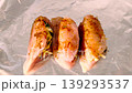 Raw chicken breast rolls stuffed with cheese and herbs seasoned with spices on foil. 139293537