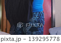 Man folding and placing clean clothes into wardrobe at home, organizing laundry and maintaining tidy storage space, daily routine of clothing arrangement and home organization indoors 139295778