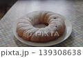 Powdered sugar is sprinkled on top of a freshly baked pie on the kitchen counter 139308638