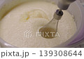 Close-up, cream ingredients falling into a plastic bowl and whipping with a hand mixer 139308644