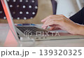 Woman hands typing on laptop keyboard in close-up side view, entering text and working online, modern digital workflow, remote job, communication and everyday computer usage 139320325