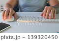 Man using keyboard and mouse at computer desk in front view, switching between typing and cursor control, working on pc, handling digital tasks, office workflow and online activity process 139320450