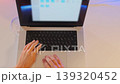 Overhead shot of woman typing on laptop keyboard in minimal workspace with soft gradient lighting, freelance workflow, online tasks, modern digital lifestyle and remote office environment 139320452
