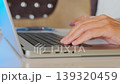 Female hand using laptop touchpad in close-up, navigating interface and browsing online content, cursor control and digital interaction, everyday computer usage and internet activity 139320459