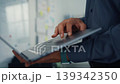 Thoughtful young Latin businessman stand with laptop analyzing data above paperwork stack. Hybrid work audit, digital transformation strategy, business corporate finance, executive decision concept. 139342350