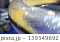 Close up of yellow granular plastic material moving through transparent industrial tubes in a modern processing system. Plastic manufacturing automation engineering and production technology concept. 139349692
