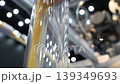 Close up of yellow granular plastic material moving through transparent industrial tubes in a modern processing system. Plastic manufacturing automation engineering and production technology concept. 139349693
