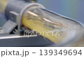 Close up of yellow granular plastic material moving through transparent industrial tubes in a modern processing system. Plastic manufacturing automation engineering and production technology concept. 139349694