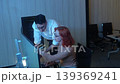 Programmers working at night analyzing code on monitors in a modern office. Software developers collaborating on debugging cybersecurity and data programming projects. Ai coding Software technician. 139369241