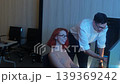 Programmers working at night analyzing code on monitors in a modern office. Software developers collaborating on debugging cybersecurity and data programming projects. Ai coding Software technician. 139369242