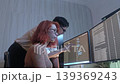 Programmers working at night analyzing code on monitors in a modern office. Software developers collaborating on debugging cybersecurity and data programming projects. Ai coding Software technician. 139369243
