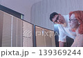 Programmers working at night analyzing code on monitors in a modern office. Software developers collaborating on debugging cybersecurity and data programming projects. Ai coding Software technician. 139369244