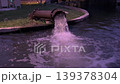 Water discharges from a large metal pipe into a canal, creating splashes and turbulence, industrial drainage system in outdoor setting, infrastructure managing flow, environmental and utility concept 139378304