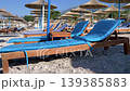 Organized beach area with sunbeds and umbrellas on 139385883