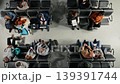Talking, catching plane and top down view of people in busy airport terminal waiting. Chatting, boarding departure gate and high angle shot of diverse travelers with luggage and plane tickets Talking, catching plane and top down view of people in busy airport terminal waiting. Chatting, boarding departure gate and high angle shot of diverse travelers with luggage and plane tickets 139391744