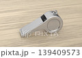 Silver referee whistle on a wooden desk 139409573