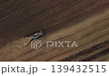 Top-down view of wheat harvester in the field. Seasonal work of harvesting grain in the agricultural field 139432515