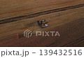 Wheat harvester loading cargo truck with gathered grain while working on the field. Harvest on the wheat field 139432516
