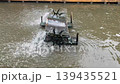 water turbine aerator splashing water in canal to increase oxygen. Wastewater treatment machine working in outdoor pond, sustainable agriculture and environmental technology in Thailand 139435521