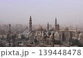 View from Cairo Citadel over Sultan Hassan Mosque and Al-Rifa'i Mosque, Egypt, with multiple minarets piercing the smoggy sky above the ancient city center. 139448478
