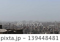 View from Cairo Citadel over Sultan Hassan Mosque and Al-Rifa'i Mosque, Egypt, with multiple minarets piercing the smoggy sky above the ancient city center. 139448481