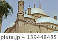 Architectural beauty of Muhammad Ali Mosque at historic Cairo Citadel, Egypt, with Ottoman domes, ornate minaret finials, arched colonnade and latticed stone windows. 139448485
