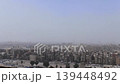 Panoramic view above dusty Cairo skyline, Egypt, with towering minarets and massive stone domes in medieval Islamic architecture. 139448492