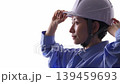 A woman in work clothes wearing a helmet 139459693