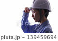 A woman in work clothes wearing a helmet 139459694