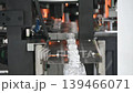 The  empty drinking water bottles  on the conveyor belt from blow mold machine. The hi-technology of drinking water manufacturing process.  139466071