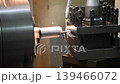Slow motion scene the lathe machine finish cut metal shaft parts with liquid coolant method. The metalworking process by turning machine. 139466072