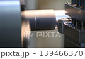 The lathe machine finish cut metal shaft parts with liquid coolant method. The metalworking process by turning machine. 139466370