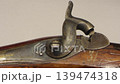 The trigger of an antique flintlock rifle 139474318