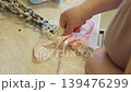 Woman Decorating Willow Branches with Pink Ribbon for Easter Celebration 139476299
